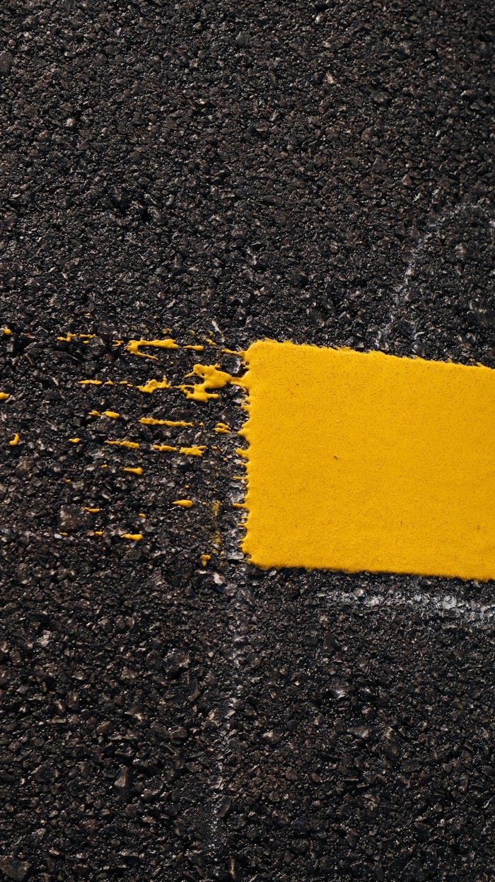 Freshly sealed black asphalt surface with road markings